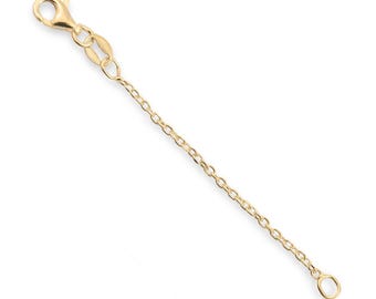 May include: A gold-toned metal necklace extender chain featuring a polished finish. The chain consists of small, oval-shaped links and is equipped with a secure lobster claw clasp at one end and a small, circular jump ring at the other end.
