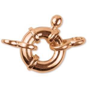 Puede incluir: Un cierre de langosta de oro rosa con un anillo redondo y una pequeña bola en la parte superior.