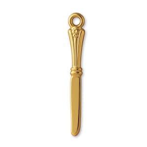 May include: A gold-coloured butter knife with a decorative handle and a small loop at the top. The handle features vertical lines and floral accents. The blade is smooth and rectangular.