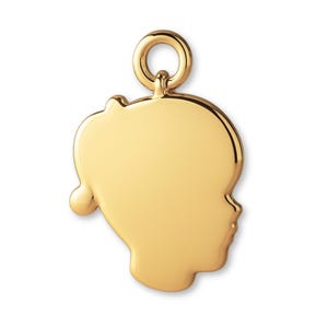 May include: A polished gold-tone metal pendant shaped like the silhouette of a child's head in profile. The smooth, reflective surface features a rounded top loop for attachment, creating a simple, clean, and uniform metallic appearance.