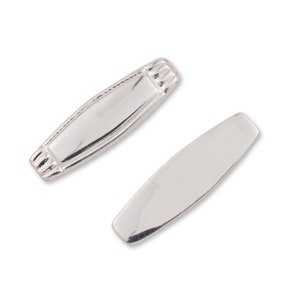 May include: Two silver-toned metal rectangular nameplate tags with rounded edges. The top tag has a decorative border around the edges.