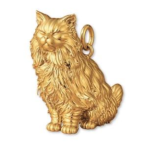 May include: A gold-coloured pendant depicting a fluffy cat in a seated position with closed eyes. The pendant features intricate detailing, with a textured surface and a loop for a chain. The cat's fur is finely sculpted, creating a realistic look.