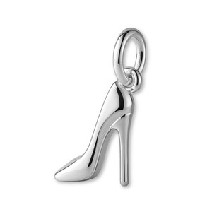 May include: A polished silver-toned charm shaped like a high-heeled shoe, featuring a smooth, reflective surface and a circular jump ring attached at the top for easy connection to a bracelet or necklace chain.