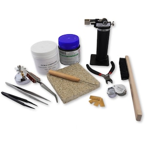 May include: A jewelry making kit with a variety of tools, including a torch, tweezers, a magnifying glass, a brush, a pickle compound, flux paste, and a soldering block.
