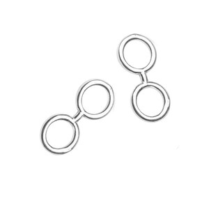 May include: Two silver jump rings, each with two connected circles. The rings are designed to be used for connecting jewelry pieces.