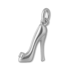 May include: A silver-toned metal charm shaped like a high-heeled shoe. The charm features a pointed toe with a small bow detail at the front and a slender stiletto heel. A circular jump ring is attached to the top for hanging purposes.