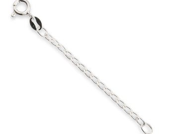 May include: A silver-toned metal necklace extender chain featuring a circular spring ring clasp at one end and a small jump ring at the other. The chain consists of a series of oval-shaped links connected in a simple, uniform pattern.