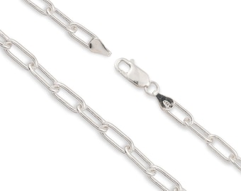 May include: A silver chain necklace featuring elongated rectangular links with rounded edges. The chain includes a lobster claw clasp mechanism and a small metal tag stamped with the number 925, indicating sterling silver composition.