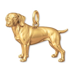 May include: A gold-colored pendant in the shape of a dog, likely a Vizsla, standing on all fours. The pendant has a loop at the top for a chain. The dog is detailed with realistic features.