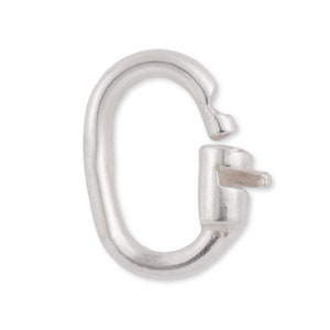 May include: Silver-toned metal clasp with a hook and loop closure. The clasp is oval-shaped and has a smooth finish.