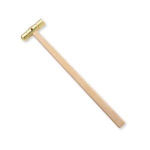 May include: A small hammer featuring a polished gold-tone metal head with a cylindrical shape and a single black dot detail on the side, attached to a long, straight, light-colored wooden handle with a smooth, natural grain finish.