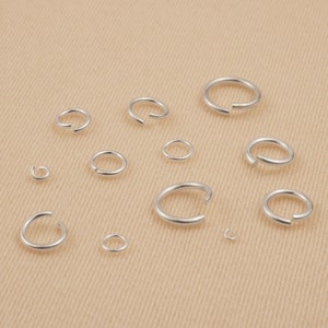 May include: Assortment of silver jump rings in various sizes, perfect for jewelry making or crafting projects.
