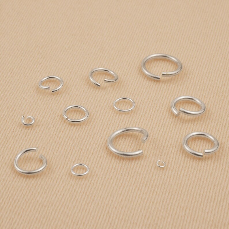 May include: Assortment of silver jump rings in various sizes, perfect for jewelry making or crafting projects.