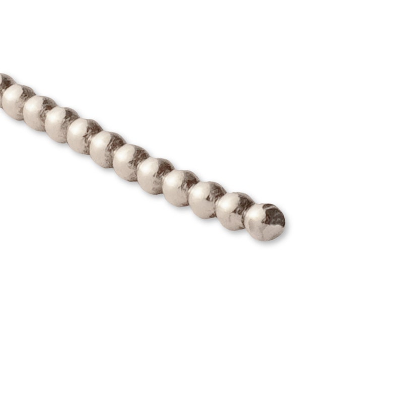 May include: A silver beaded chain with a smooth, rounded finish. The chain is made of small, evenly spaced beads.