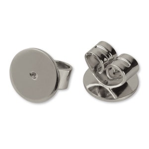 May include: A pair of silver earring backs with a post and a butterfly clutch. The earring backs are designed to be used with stud earrings.