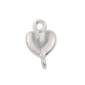 May include: Silver heart charm with a loop at the top and a small loop at the bottom.