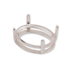 May include: A silver-toned metal oval ring setting featuring a double-layered band structure and four vertical prongs extending upward, designed to hold a gemstone in a secure, elevated position for jewelry assembly and crafting.