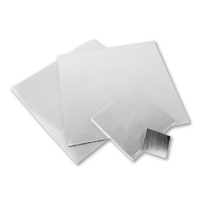 May include: Three silver sheets of metal in different sizes. The largest sheet is in the background, and the smallest sheet is in the foreground.