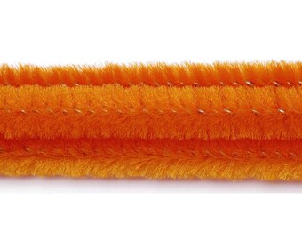 May include: Close-up of three orange chenille stems, also known as pipe cleaners, against a white background. The stems are thick and fluffy, with a soft, fuzzy texture. These craft supplies are often used for various DIY projects.