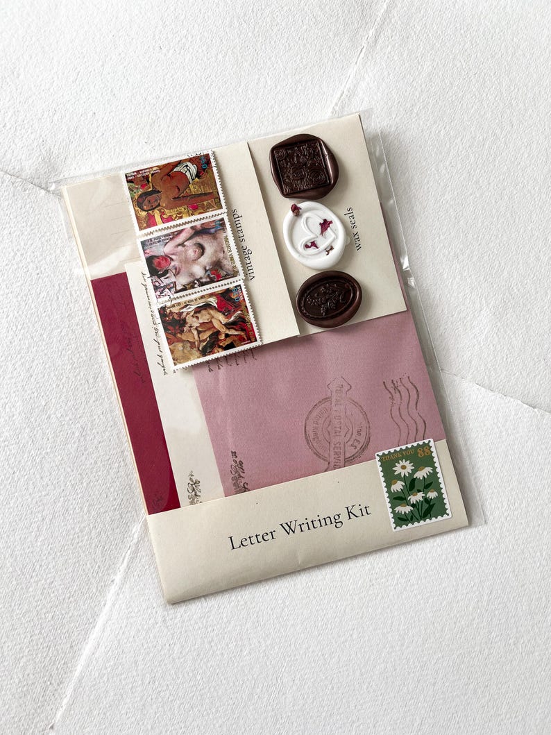 May include: A letter writing kit with a pink envelope, a white envelope, a red envelope, three wax seals, three vintage stamps, and a "Thank You" stamp with white daisies.