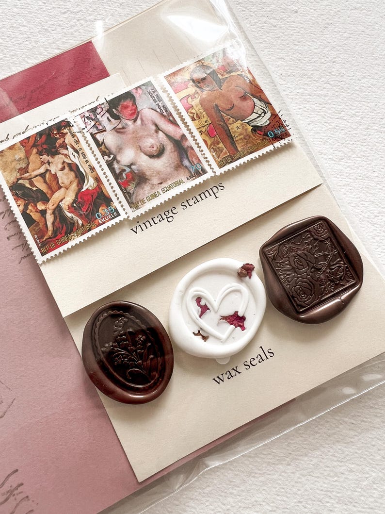 May include: A set of three wax seals, two brown and one white. The brown seals have floral designs and the white seal has a heart shape. The seals are displayed on a white card with the text "vintage stamps" and "wax seals".