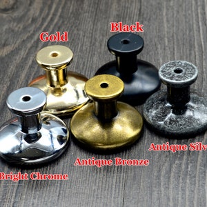 May include: Five different cabinet knobs in various finishes: bright chrome, antique bronze, antique silver, gold, and black.