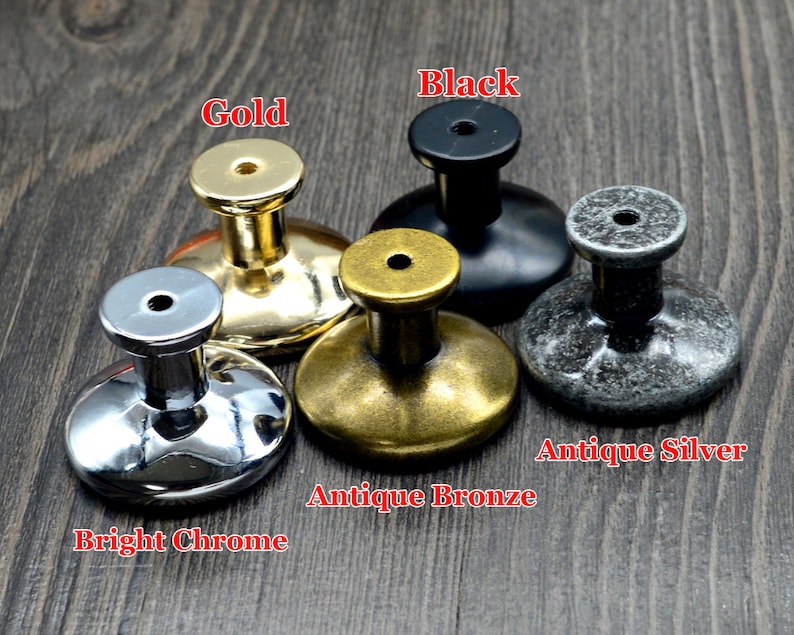 May include: Five different cabinet knobs in various finishes: bright chrome, antique bronze, antique silver, gold, and black.