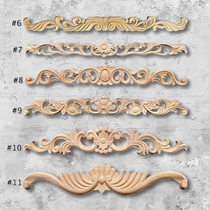 May include: Six decorative wooden carvings, each featuring floral and scroll patterns. The pieces, numbered #6 to #11, are displayed against a textured grey backdrop. The wood has a natural, light brown colour, with detailed craftsmanship.
