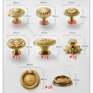 May include: A selection of gold-toned cabinet knobs and pulls in diverse designs. Measurements are in millimeters. Styles include round, floral, and geometric patterns. Sizes vary from 2.7cm to 4.8cm in width.