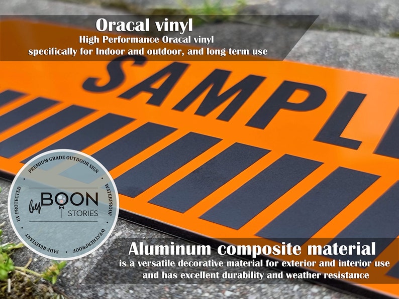 May include: A close-up of a black and orange sign with the word "SAMPLE" printed in black letters. The sign is made of aluminium composite material and is labelled as a premium grade outdoor sign. The sign is waterproof, fade resistant, and UV protected.