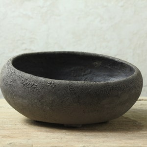 Oval and asymmetrical pot with lava effect glaze