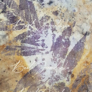 May include: A close-up of a fabric with a mottled purple and brown pattern. The name "Beata Jarmolowska" is written in white cursive script three times.