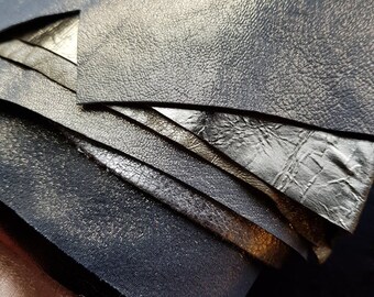 May include: Close-up of a stack of leather pieces in various shades of gold and silver. The leather has a textured surface and a metallic sheen.