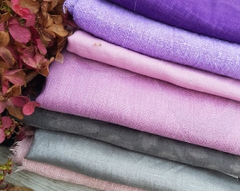 May include: A stack of fabric swatches in shades of purple, pink, and gray. The fabric is a linen blend and has a soft, textured feel.