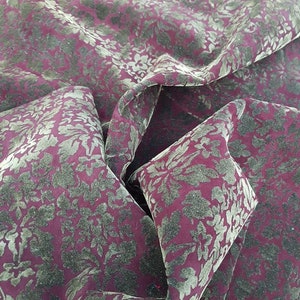 May include: Burgundy velvet fabric with a gold floral pattern.