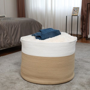 May include: A white and beige rope storage basket with a white fluffy liner. The basket is filled with blue jeans.