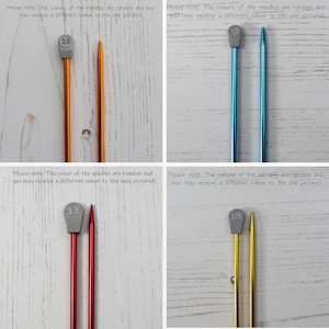 May include: Four knitting needles with different colored tips and gray plastic caps. The needles are labeled 3.0, 3.5, and 3.75. The needles are on a wooden surface.
