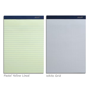 May include: Two writing pads with dark blue binding. One pad has pastel yellow lined paper, and the other has white grid paper. The brand name is printed in silver on the top of each pad. The text "Pastel Yellow Lined" and "White Grid" are below each pad.