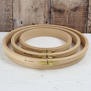 May include: Three wooden embroidery hoops, nested together. The hoops are labelled "Nurge No. 4", "Nurge No. 5", and "Nurge No. 8".