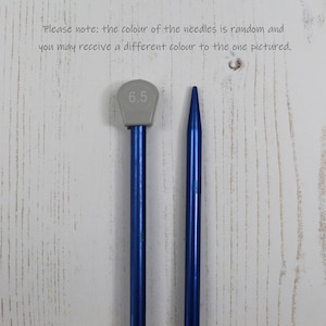 May include: A pair of blue knitting needles with a gray plastic tip. The tip of one needle is labeled "6.5".