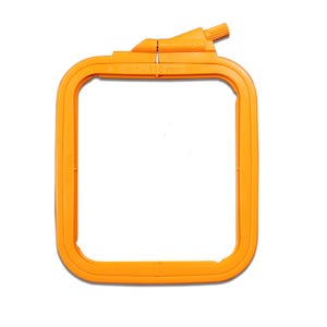 May include: Orange plastic embroidery hoop with a 7.5 inch by 11.0 inch opening. The hoop has a screw-on closure.