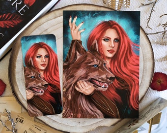 May include: A red-haired woman with a wolf beside her. The woman is wearing a dark brown shirt and has a blue background with white streaks. The wolf has blue eyes and is looking at the viewer.