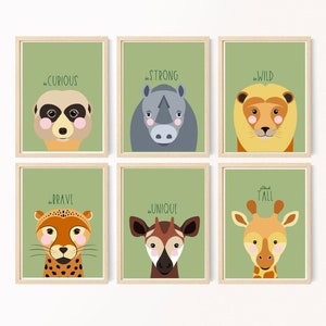May include: Six framed prints with green backgrounds and animal illustrations. Each print features a different animal and a motivational phrase. The phrases are "be curious", "be strong", "be wild", "be brave", "be unique", and "stay tall".
