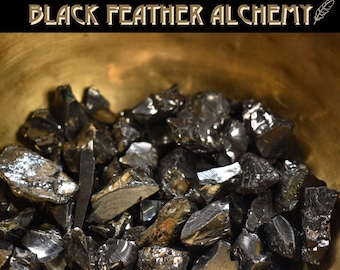 May include: A close-up of a bowl filled with black obsidian chips. The bowl is made of brass and has a shiny, golden finish.