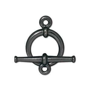 May include: A black metal toggle clasp with a round ring and a bar. The clasp is designed for jewelry making.