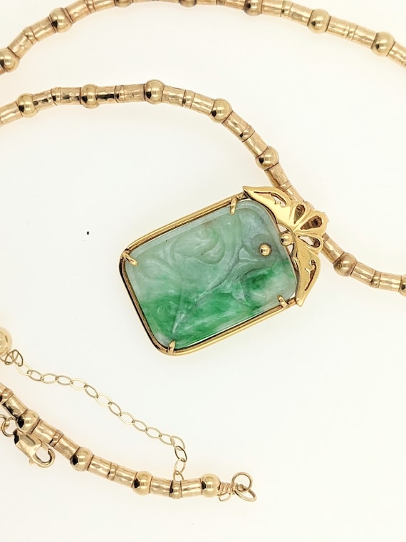 Jade pendant and gold beaded necklace