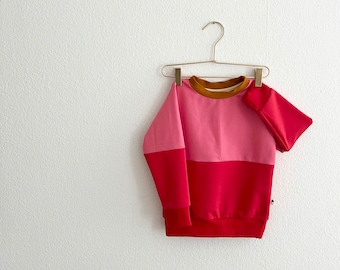 der "Knallbonbon" Colourblock Sweater in pink und rot