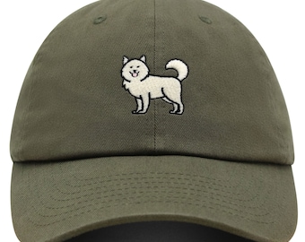 May include: A green baseball cap with an embroidered white dog on the front.