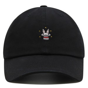 May include: A black baseball cap with a white rabbit and a red and white top hat embroidered on the front. The rabbit is in a magic hat with stars around it.