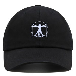 May include: A black baseball cap with a white embroidered image of the Vitruvian Man, a famous drawing by Leonardo da Vinci.